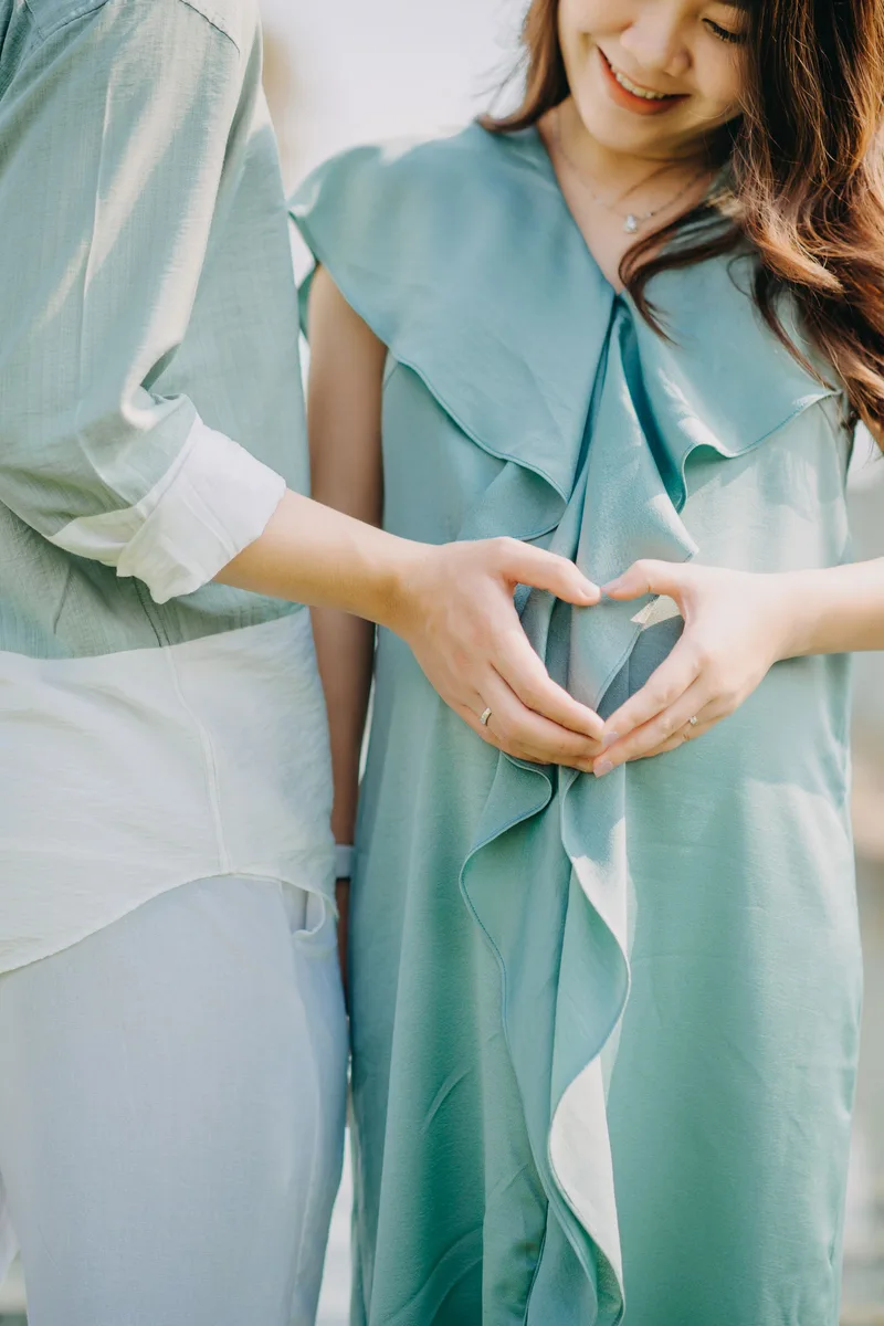 Couple forming a heart shape with their hands