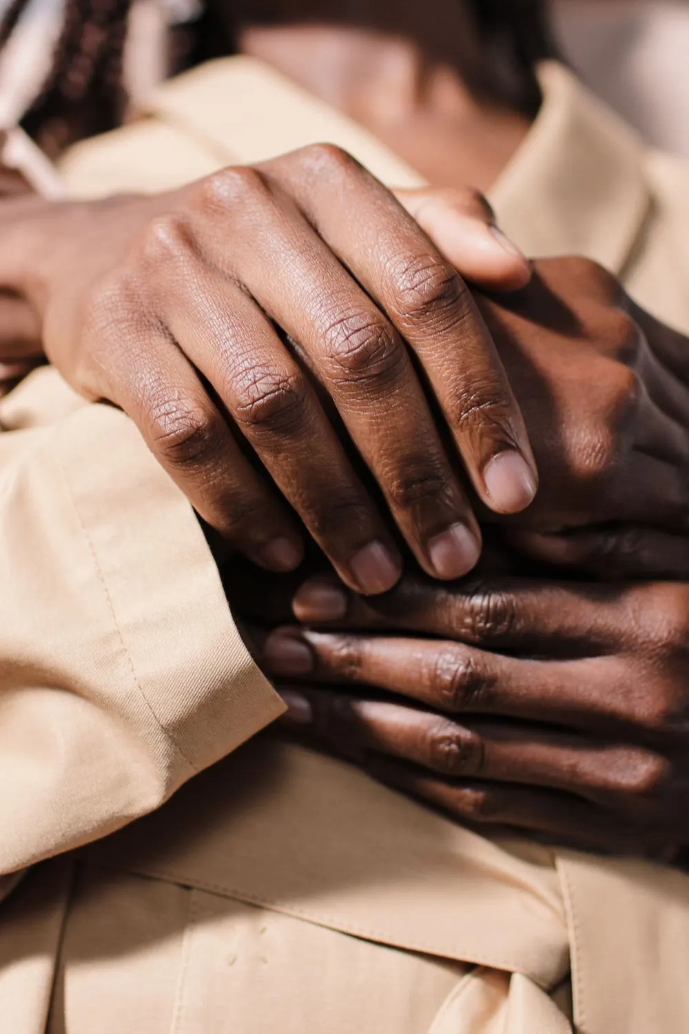 Couple holding each other’s hands in support