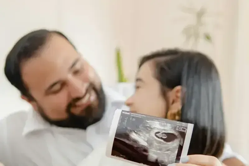 Happy couple with ultrasound photo