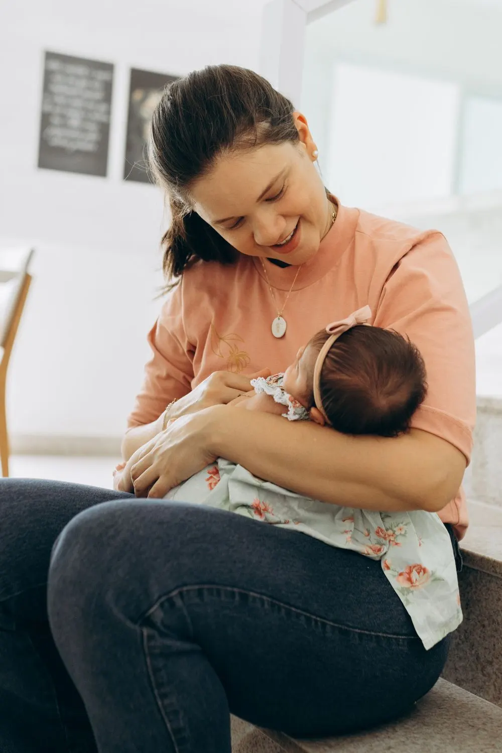 Smiling mother cradling her newborn baby